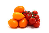 Several red and yellow ripe tomatoes on a light background. Natural product. Natural color. Close-up.