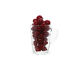 Ripe cherry in a transparent glass on a light background. Natural product. Natural color. Close-up
