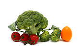 Raw Inflorescences of broccoli and tomatoes of different colors and sizes on a light background. Natural product. Natural hue. Close-up.