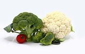 Inflorescences of broccoli and cauliflower and red ripe tomatoes on a light background. Natural product. Natural hue. Close-up.