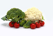 Inflorescences of broccoli and cauliflower and red ripe tomatoes on a light background. Natural product. Natural hue. Close-up.