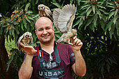 Northern white-faced owl (Ptilopsis leucotis) juveniles on a photographer, Togo. Sub-saharan Africa to Ecuador