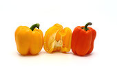 Three sweet peppers in yellow and orange on a light background. Natural product. Natural color. Close-up.