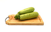 Three zucchini on a light background. Natural product. Natural color. Close-up.