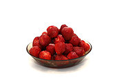 Ripe strawberries with sugar in a translucent plate on a light background. Natural color and shape. Close-up.