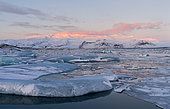 The glacial lagoon Joekulsarlon, Vatnajoekull NP, Iceland. The glacial lagoon Joekulsarlon with glacier Breithamerjoekull in the Vatnajoekull NP. Sunrise. In the background is peak Oeraefajoekull, the highst mountain in Iceland. europe, northern europe, iceland, February