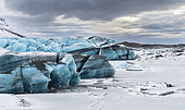 Svinafellsjoekull glacier in Vatnajoekull NP during Winter, Icel. Svinafellsjoekull glacier in Vatnajoekull NP during Winter, view over the frozen glacial lake and the melting glacial front. europe, northern europe, scandinavia, iceland, February