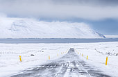 Landscape in Skagafjoerdur during winter, Iceland. Landscape in Skagafjoerdur during winter. view of a snowed in country road with the fjord in the background europe, northern europe, iceland, March