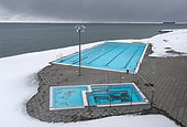 Hofsos at Skagafjoerdur during winter, Iceland. Hofsos, a traditional fishing village with many historic buildings on the coast of Skagafjoerdur during winter. The municipal swimming pool. europe, northern europe, iceland, March