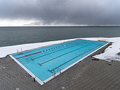 Hofsos at Skagafjoerdur during winter, Iceland. Hofsos, a traditional fishing village with many historic buildings on the coast of Skagafjoerdur during winter. The municipal swimming pool. europe, northern europe, iceland, March