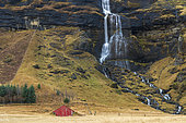 Water fall and barn near Vik, Iceland.