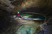 Man and boat in Krizna Jama Cave, Cross Cave, Grahovo, Slovenia.