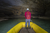 Man in a boat in Krizna Jama Cave, Cross Cave, Grahovo, Slovenia.