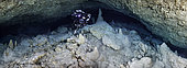The cave in panoramic view. A panorama made up of 12 photos to capture the grandeur and beauty of this underwater cave. Here we are about 90 metres from the entrance and 70 metres deep. We can see that the ground, covered with a thin layer of sediment, is strewn with fragments of stalactites. A place that has not changed since the cave was last immersed, some 12,000 years ago.Underwater cave, Mayotte