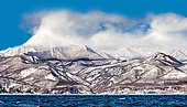 Hokkaido island coastline with hills, beautiful clouds, sky and sea. Japan. Sea of Okhotsk. Kunashir Strait.