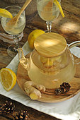 Ginger drink. Ginger and lemon drink in the garden in a teapot and glasses - antioxidant, anti-inflammatory, anti-bacterial, medicinal rhizome, benefits, health