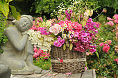Bouquet of Sweet Peas (Lathyrus odoratus), Crops honesty (Lunaria annua), Hydrangea (Hydrangea sp), Rose (Rosa sp), Aster 'Aster sp), Zen spirit statue, in the garden