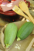 Courgettes (Cucurbita pepo) and 'Bolognese' courgette seeds from the Kokopelli association, wooden kitchen utensils