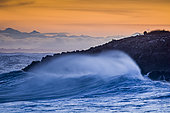Waves breaking on the rocks of the corniche at sunset, storm on Sète, Hérault, Languedoc-Roussillon, France