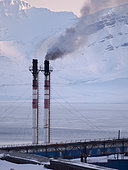 The chimneys of the power plant. Russian coal mining town Barentsburg at fjord Groenfjorden, Svalbard. The coal mine is still in operation. Arctic Region, Europe, Scandinavia, Norway, Svalbard