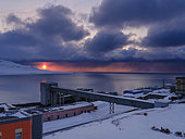 Sunset over the mine. Russian coal mining town Barentsburg at fjord Groenfjorden, Svalbard. The coal mine is still in operation. Arctic Region, Europe, Scandinavia, Norway, Svalbard