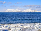 Coast near Kapp Linne at fjord Isfjorden near Isfjord Radio, Island of Spitsbergen, part of Svalbard archipelago. Background mountains of Nordre Isfjorden NP. Arctic region, Europe, Scandinavia, Norway, Svalbard