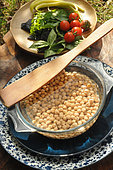 Chick pea (Cicer arietinum), peas soaking in water before cooking and seasonal vegetables