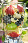 Fruit mix in a blender, apples, grapes, blackberries, banana, for homemade compote and juice