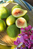 White figs (Ficus carica) in a wooden plate