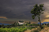 Village of Suzette under a stormy sky, in the Dentelles de Montmirail, Vaucluse, France