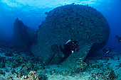 Rebreather diver exploring the stern with the propeller of the Chrisoula K, “The Tile Wreck” Abu Nuhas, Egypt. Strait of Gubal, Gulf of Suez, Red Sea