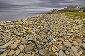 Pebble beach near the jetty at the historic site of Sandsayre pier, starting point of the crossing to the Isle of Moussa, Shetland, Scotland