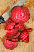 Beetroot (Beta vulgaris) cut on a kitchen board