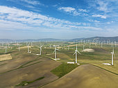 Windmills on a wind farm near Zahara de los Atunes. Aerial view. Drone shot. Cádiz province, Andalusia, Spain.