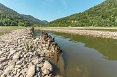 Water level drops in mountain lake in summer. Wildenstein, Vosges, Alsace, France, Europe