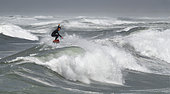 Surfer at La Torche surf spot, Finistère, Brittany, France