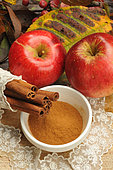 Cinnamon peel and powder and red apple