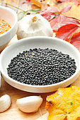 Beluga lentils (Lens culinaris) or lentil caviar and garlic pod (Allium sativum)
