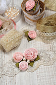 Decorated with artificial flowers, lace, gold ribbon and beads