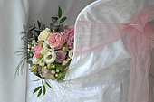 Wedding bouquet on an armchair, Rose (Rosa sp), Gypsophila (Gypsophila paniculata) and foliage, romantic atmosphere