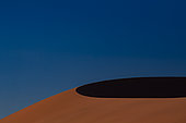 Sand dune under blue sky, Sossusvlei, Namib-Naukluft National ParK Park and National Reserve, Namibia