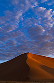 Sand dune under cloudy sky, Sossusvlei, Namib-Naukluft National ParK Park and National Reserve, Namibia
