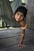 Nicaragua, San Juan de Nicaragua. Portrait of a 7-year-old Rama girl in a hammock living along the Rio Indio river.