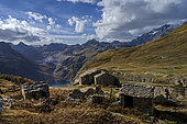 Ruined chalets in the Grande Sassière nature reserve. In the background, the resort of Tignes. This reserve of the Vanoise park is located in Haute Tarentaise, and covers an area of 2,230 ha between the upper Isère valley and the Italian border; it ranges in altitude from 1,798 m to 3,747 m, and is dominated by the Grande Sassière (3,747 m) and Tsanteleinaz (3,602 m) summits, Alps, France