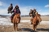 2 Kazakh eaglers on horseback on a steppe background, Mongolia