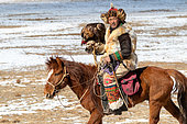 Kazakh eagler on horseback in steppe, Mongolia