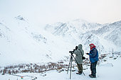 Spotters looking for the snow leopard, Himalayas, Rumbak village, Ladakh, India