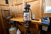 Canning maple syrup and closing the cans in a sugar shack at sugar time, Saint-Barthélemy, Lanaudière, Quebec, Canada