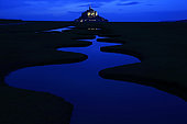 Mont-Saint-Michel at nightfall from a polder and its winding channel, Manche, Normandy, France