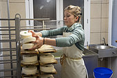 Young 20-year-old woman farmer involved in the production of Reblochon cheese on a family farm producing free-range Reblochon cheese, La Clusaz, Haute-Savoie, France